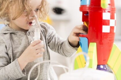 A young girl joyfully plays with a colorful toy rocket, showcasing her imagination