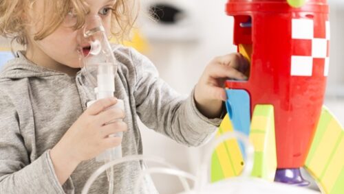 A young girl joyfully plays with a colorful toy rocket, showcasing her imagination