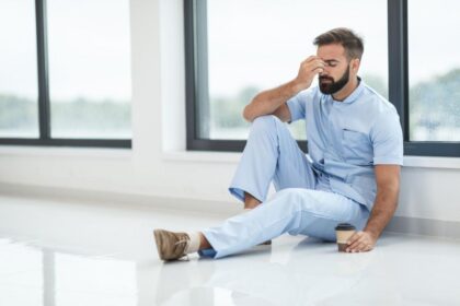 exhausted male nurse sitting on the floor