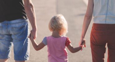 parents with child holding hands